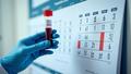 A gloved hand raises a blood vial as a wall calendar flips forward, implying detection years before symptoms in a bright clinical lab.