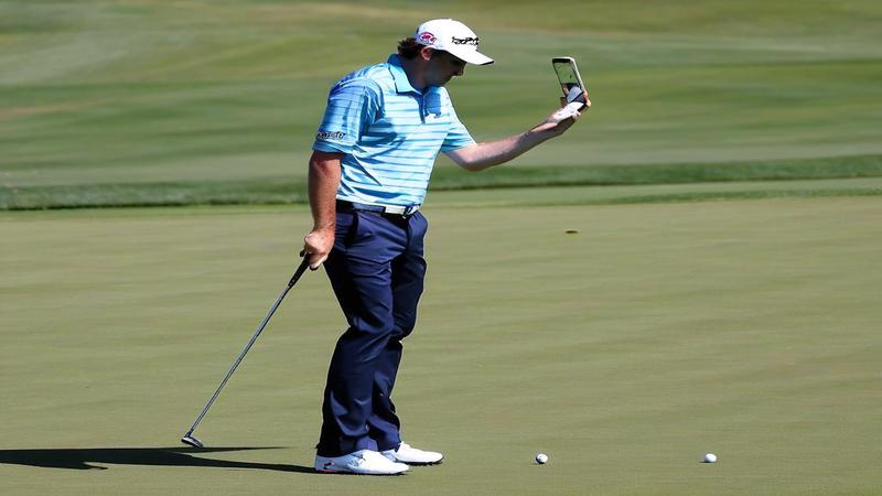 Keegan Bradley grips a phone like a 2-iron, rehearsing apologies on a practice range of missed calls.