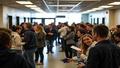 A crowded vaccination clinic lobby under fluorescent light, a maze of lines, clipboards, and hopeful faces.
