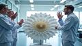 Engineers celebrate as a satellite model unfurls petal-like origami patterns in a sterile clean room.
