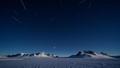Long-exposure over Antarctica with star trails and a faint streak, implying a stealth asteroid flyby that slipped past Earth while telescopes looked elsewhere.