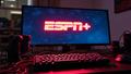 ESPN+ logo glows on a flat-screen while a designer coffee-fueled chaos swirls around a dozen tangled cables.