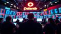 Crowded trading floor glows with screens as stock tickers spin and a blinking Palantir logo lights up the room.