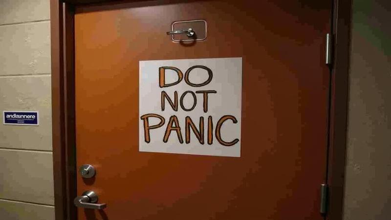 A Texas bullpen door labeled 'Do Not Panic' as players rehearse synchronized high-fives under stadium lights.