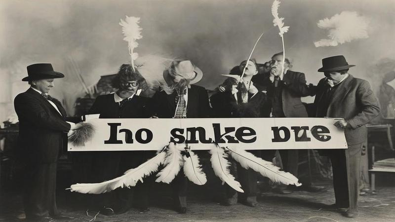 Billboard executives measure a feather boa with a yardstick while doves spell 'No.1' in smoke above.