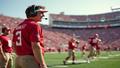 Mike Kafka grinning on sideline, headset askew, as Jaxson Dart spins a pass like a UFO auditioning for Broadway.