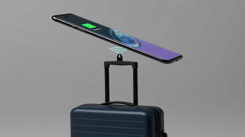 Galaxy S26 hovering over a magnetic charger as a tiny feature icon waves goodbye with a suitcase.