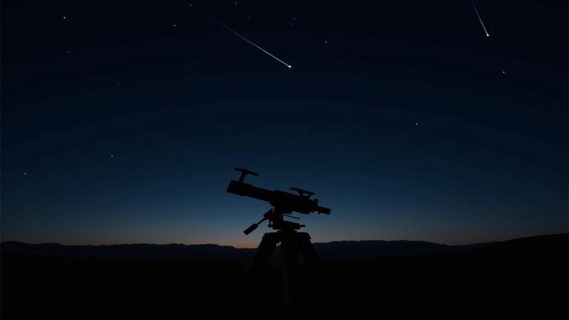 A lone telescope silhouettes against a velvet-black sky, a single Perseid comet threading the void.