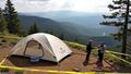 Tent surrounded by caution tape sits at a forest overlook as officials brief reporters.