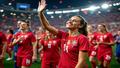 Alex Morgan waves to fans as Portugal celebrates behind her, 2-1 on the board, confetti and disbelief shimmering under stadium lights.